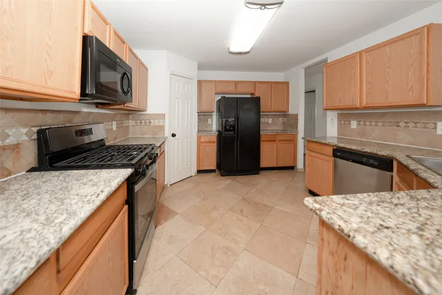 a view of a kitchen with a sink and a stove top oven