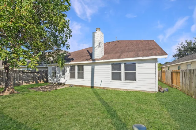 an aerial view of a house with outdoor space