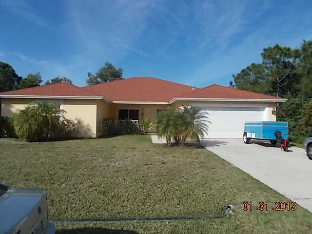 5467 Northwest Whitecap Road Port St. Lucie, FL 34986 - Photo 1 of 1 front view of a house with a yard