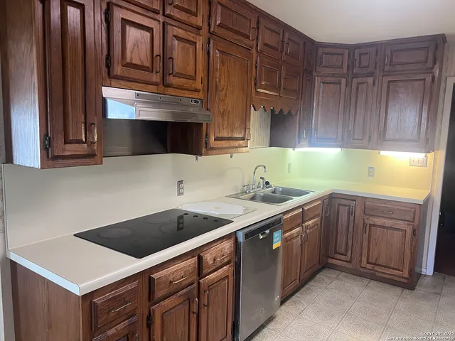 a kitchen with a sink cabinets and appliances