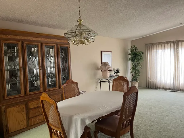 a view of a dining room with furniture window and outside view