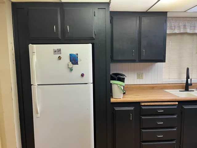 a white refrigerator freezer sitting inside of a kitchen