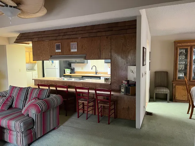 a living room with furniture a window and a kitchen