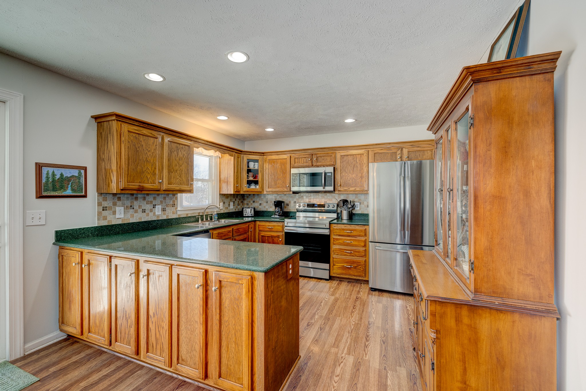 2543 Thompson Road Murfreesboro, TN 37128 - Photo 22 of 46 a kitchen with stainless steel appliances granite countertop a refrigerator and a stove top oven