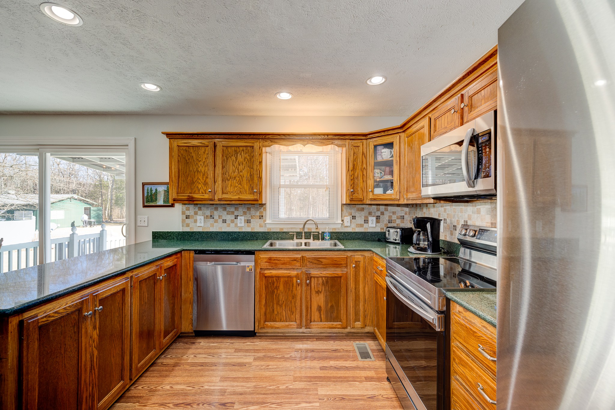 2543 Thompson Road Murfreesboro, TN 37128 - Photo 24 of 46 a kitchen with stainless steel appliances granite countertop sink stove and refrigerator