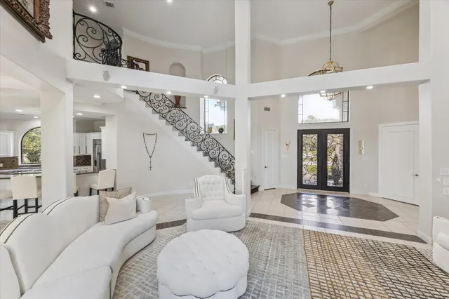 a dining room with furniture a chandelier and window