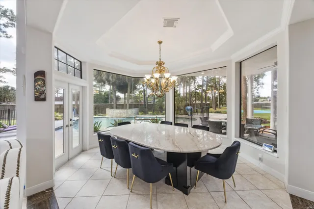 a kitchen with stainless steel appliances kitchen island granite countertop a table and chairs in it