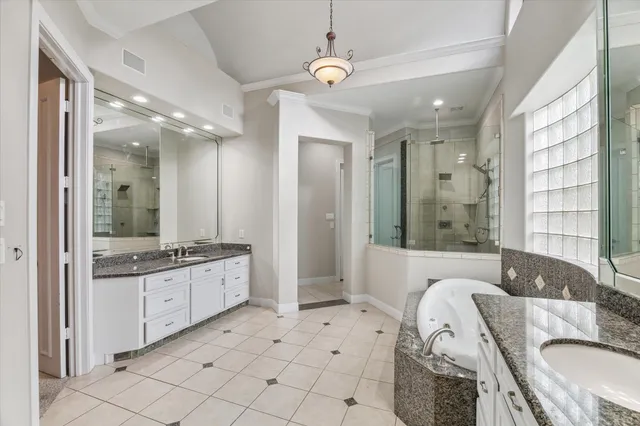 a bathroom with a granite countertop sink a toilet and shower