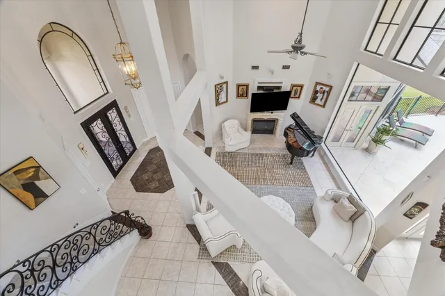 a bedroom with a large bed and a chandelier