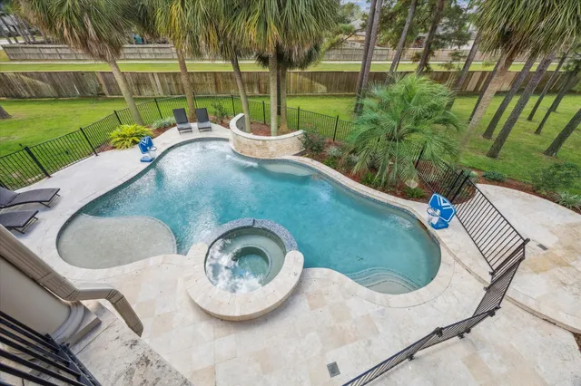 a view of a swimming pool with a patio