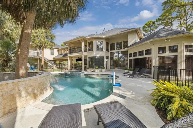 a view of a house with pool and sitting area