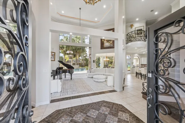 a living room with furniture a large window and a rug