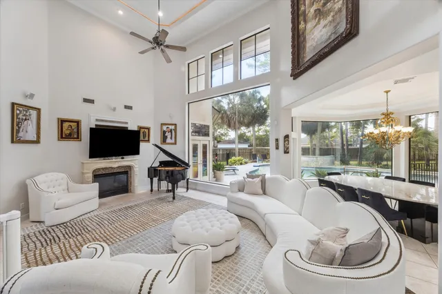 a living room with furniture a flat screen tv and a large window
