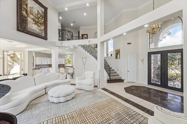 a living room with furniture and a painting on the wall
