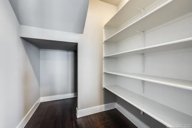 a view of walk in closet with empty racks