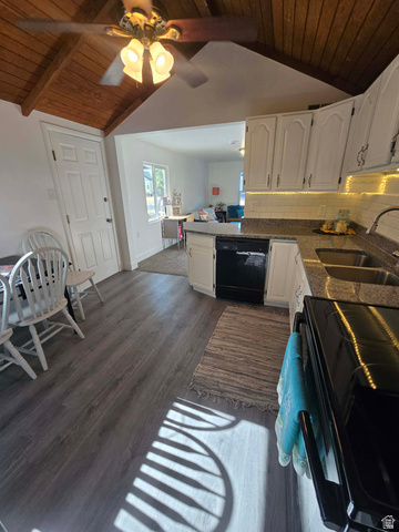 259 14th Street Ogden, UT 84404 - Photo 10 of 21 Open-concept kitchen featuring wood-finish flooring, white cabinetry, integrated appliances, and a tiled backsplash