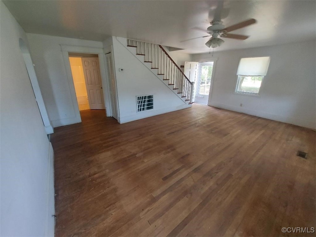 4870 Water View Road Water View, VA 23180 - Photo 3 of 14 Unfurnished living room featuring stairs, wood fin