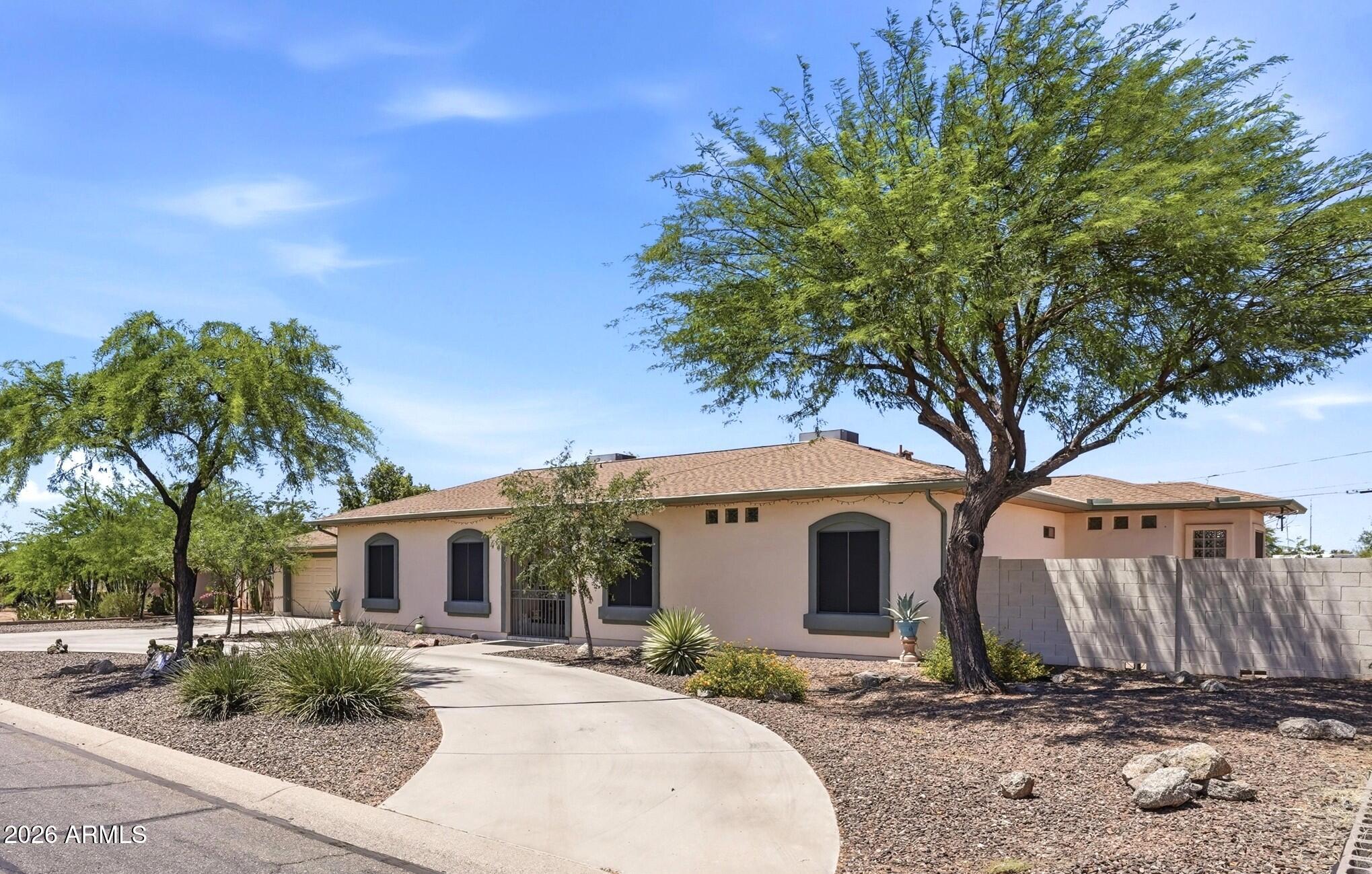 6334 East Albany Street Mesa, AZ 85205 - Photo 3 of 72 a front view of a house with garden and trees