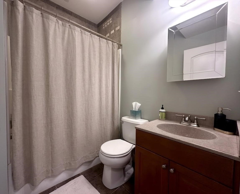 6 Wyman Street, Unit 3 Boston, MA 02130 - Photo 8 of 9 a bathroom with a toilet a sink and a mirror