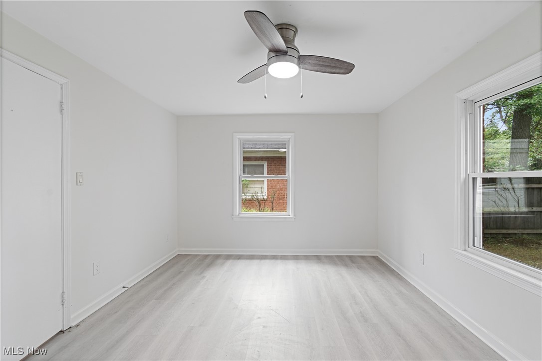 1057 Renfield Road Cleveland Heights, OH 44121 - Photo 22 of 30 Empty room with ceiling fan, plenty of natural light, and light hardwood / wood-style flooring
