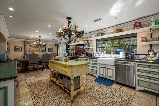 a living room with stainless steel appliances kitchen island granite countertop a table and chairs in it