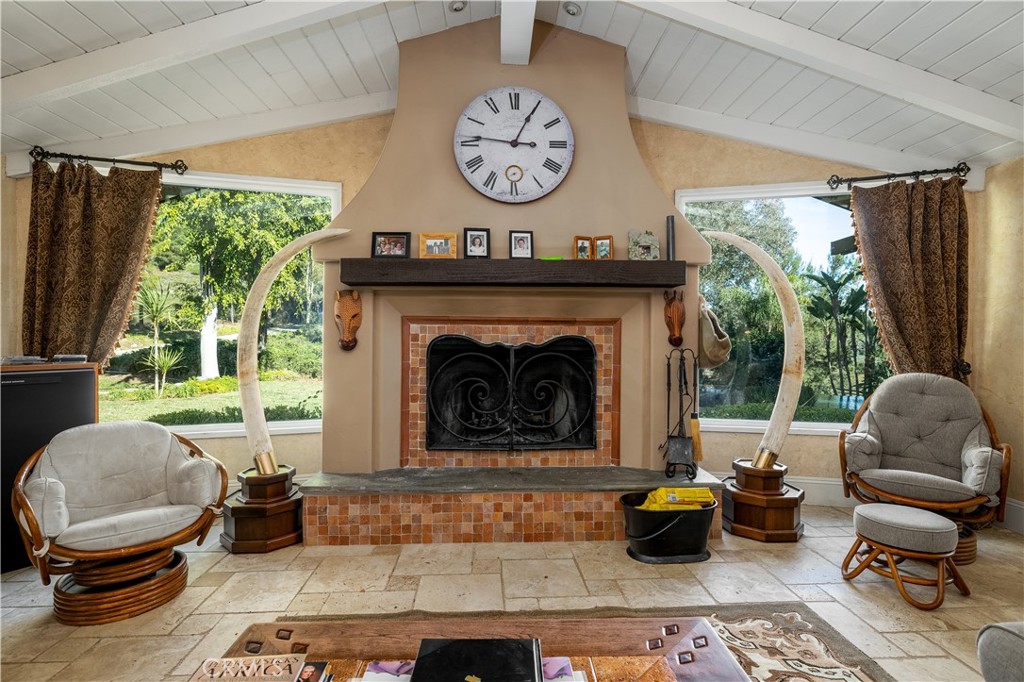 24105 Carancho Road Temecula, CA 92590 - Photo 7 of 49 Main house living room fireplace. Large window looking at infinity edge pool