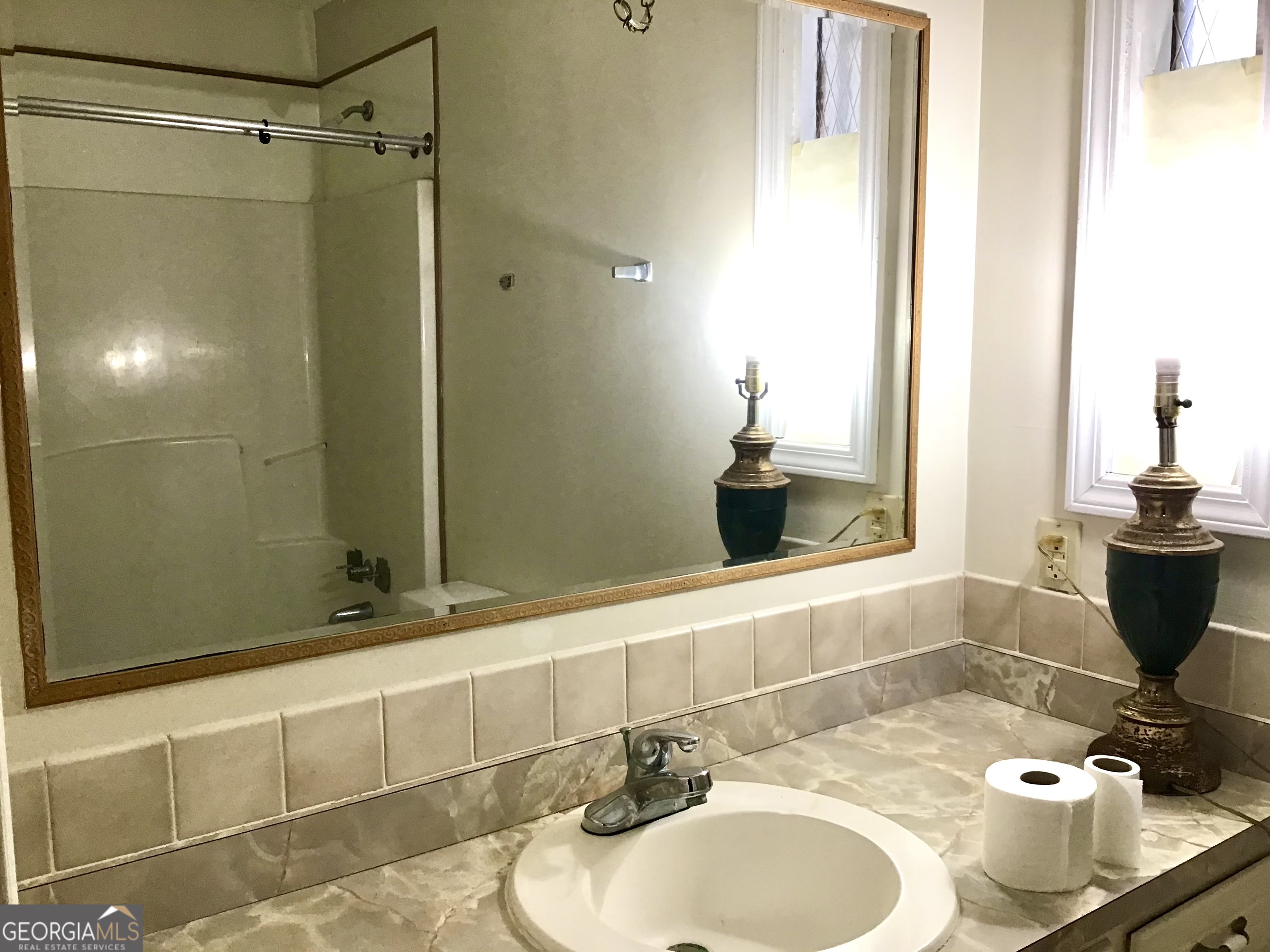 8363 Norris Lake Road Snellville, GA 30039 - Photo 15 of 28 a bathroom with a sink and a mirror