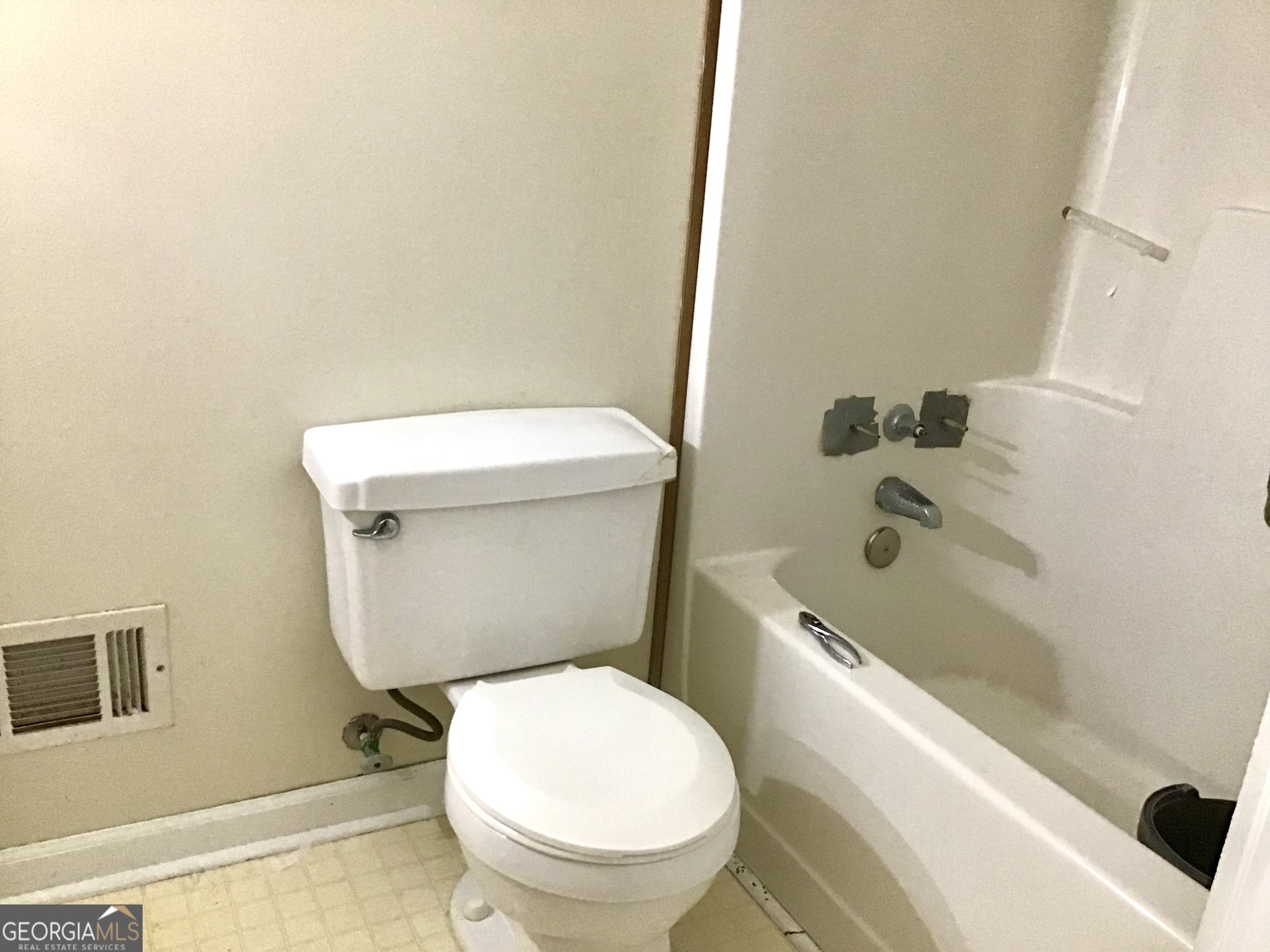 8363 Norris Lake Road Snellville, GA 30039 - Photo 17 of 28 a white toilet sitting next to a bath tub