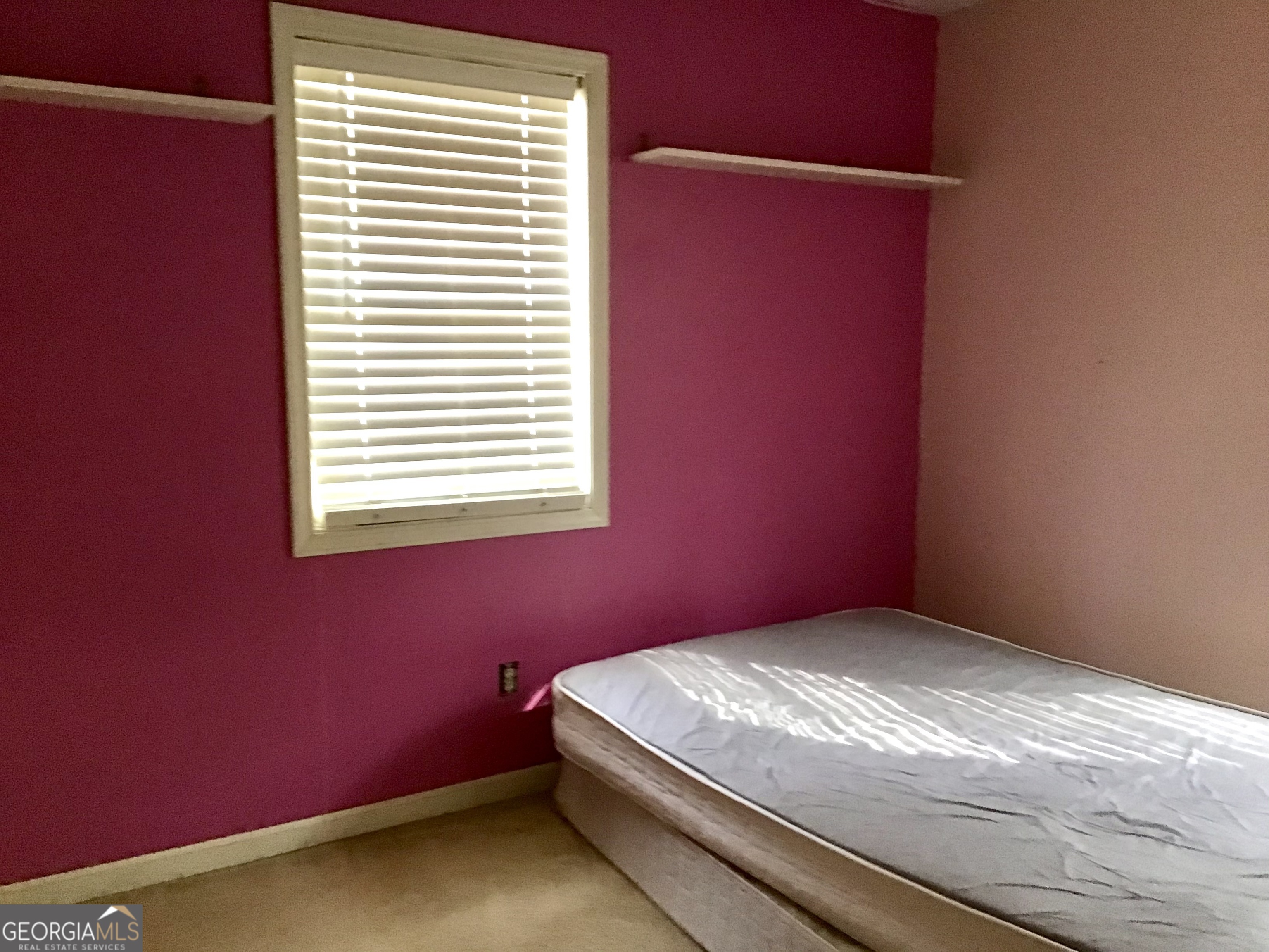 8363 Norris Lake Road Snellville, GA 30039 - Photo 20 of 28 a bedroom with a bed and a window