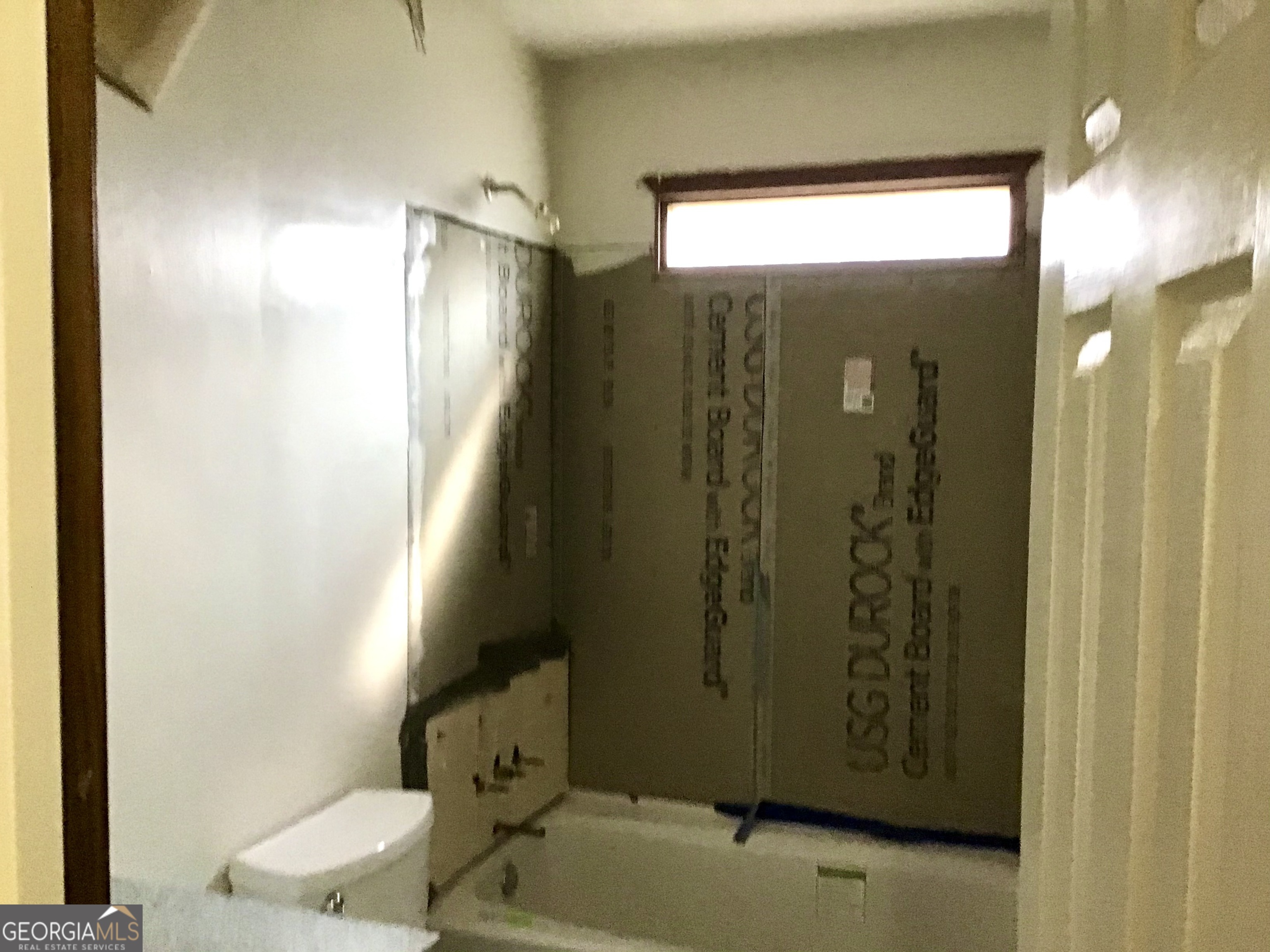 8363 Norris Lake Road Snellville, GA 30039 - Photo 23 of 28 a bathroom with a shower and a toilet