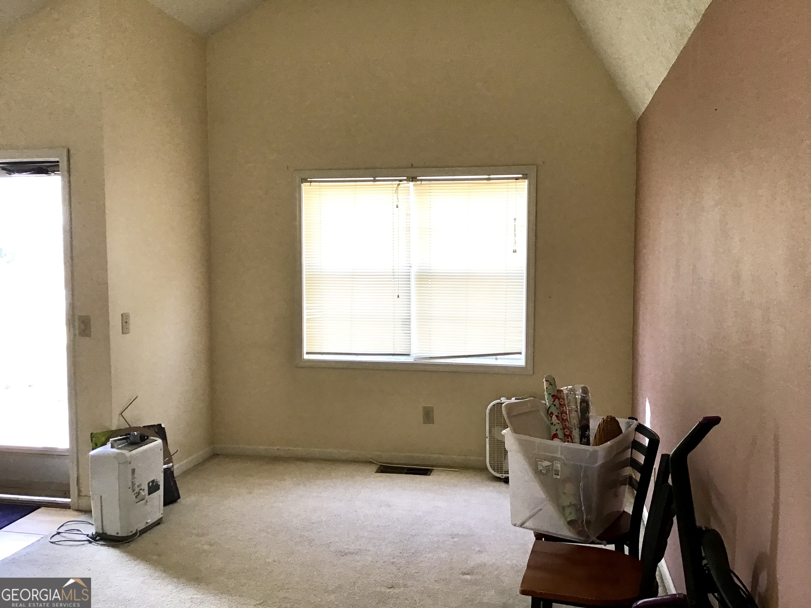 8363 Norris Lake Road Snellville, GA 30039 - Photo 6 of 28 a view of a room with a window and couch