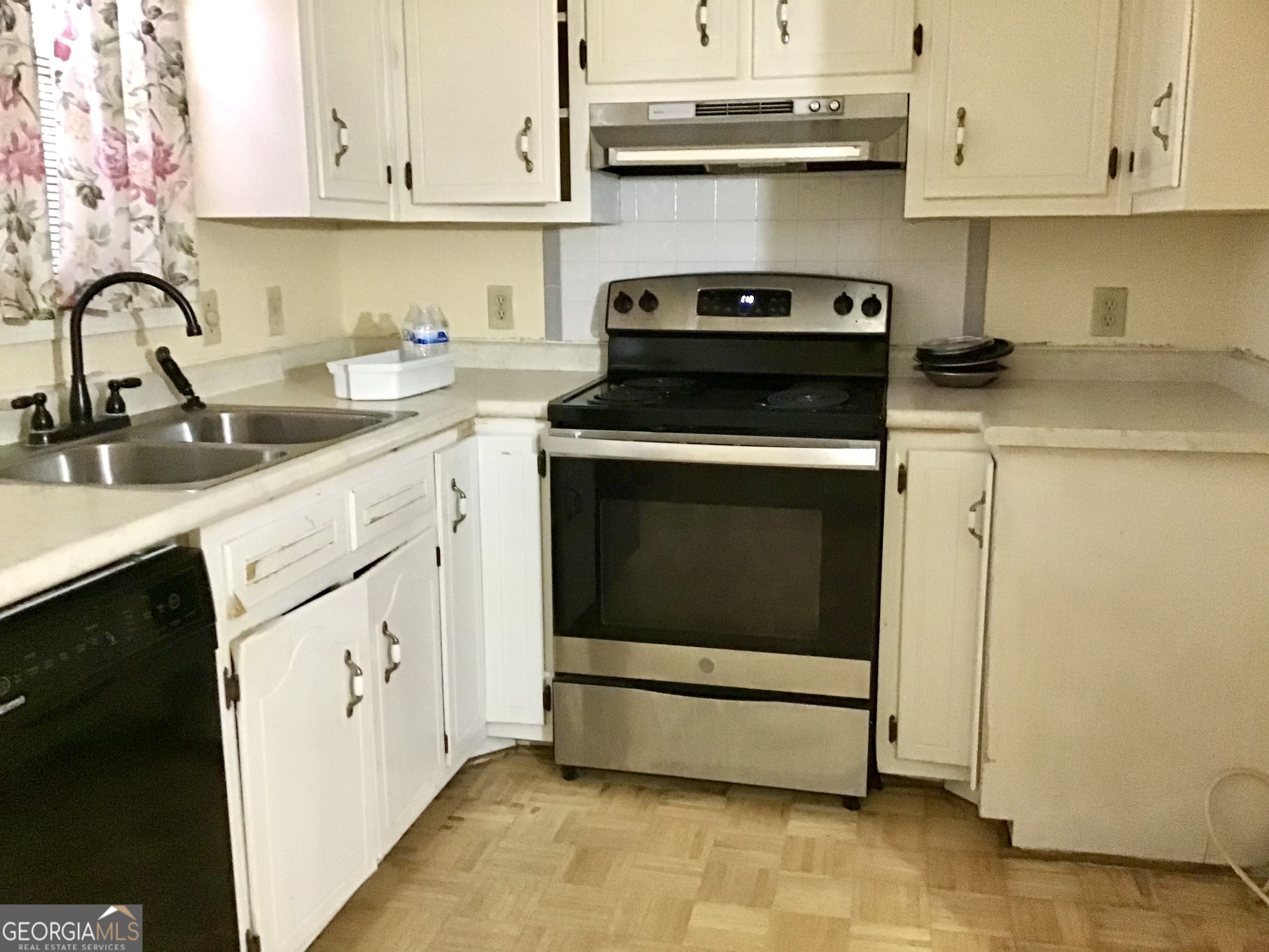 8363 Norris Lake Road Snellville, GA 30039 - Photo 10 of 28 a kitchen with granite countertop white cabinets and white appliances
