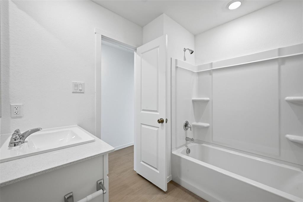 3707 Spring Run Drive Sherman, TX 75092 - Photo 14 of 18 a bathroom with a tub sink shower and a mirror