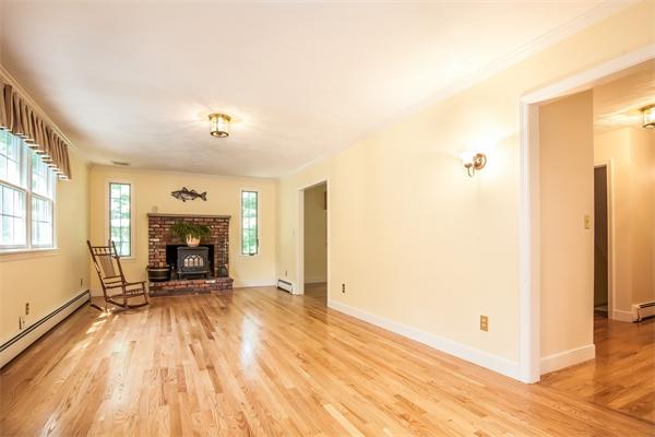 140 Waite Road Boxborough, MA 01719 - Photo 7 of 21 a view of empty room with fireplace and wooden floor