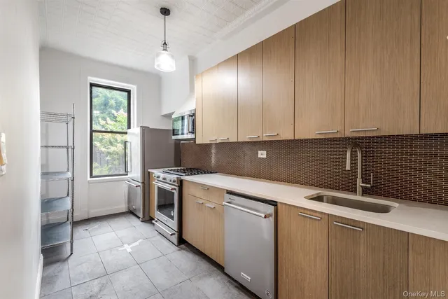 a kitchen with a sink window and cabinets