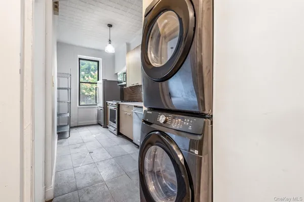 a view of a storage and utility room with washer and dryer