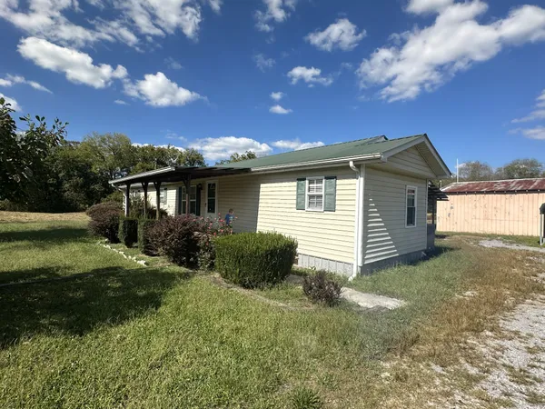 a view of a house with a yard