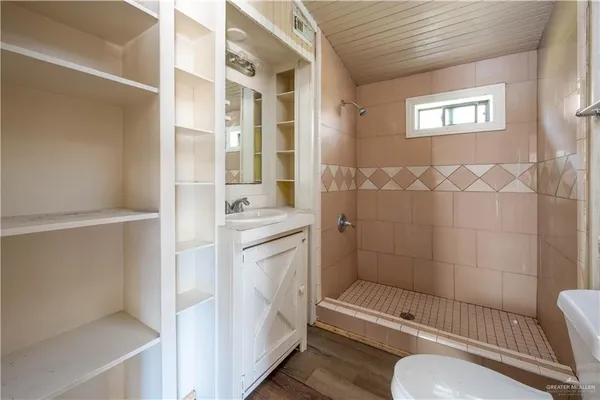a bathroom with a sink toilet and shower