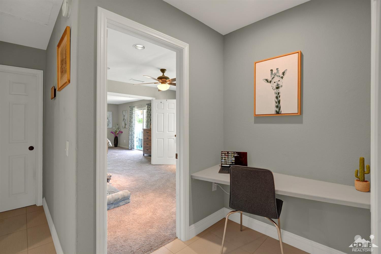 68710 Raposa Road Cathedral City, CA 92234 - Photo 13 of 29 a view of a hallway with workspace and a couch