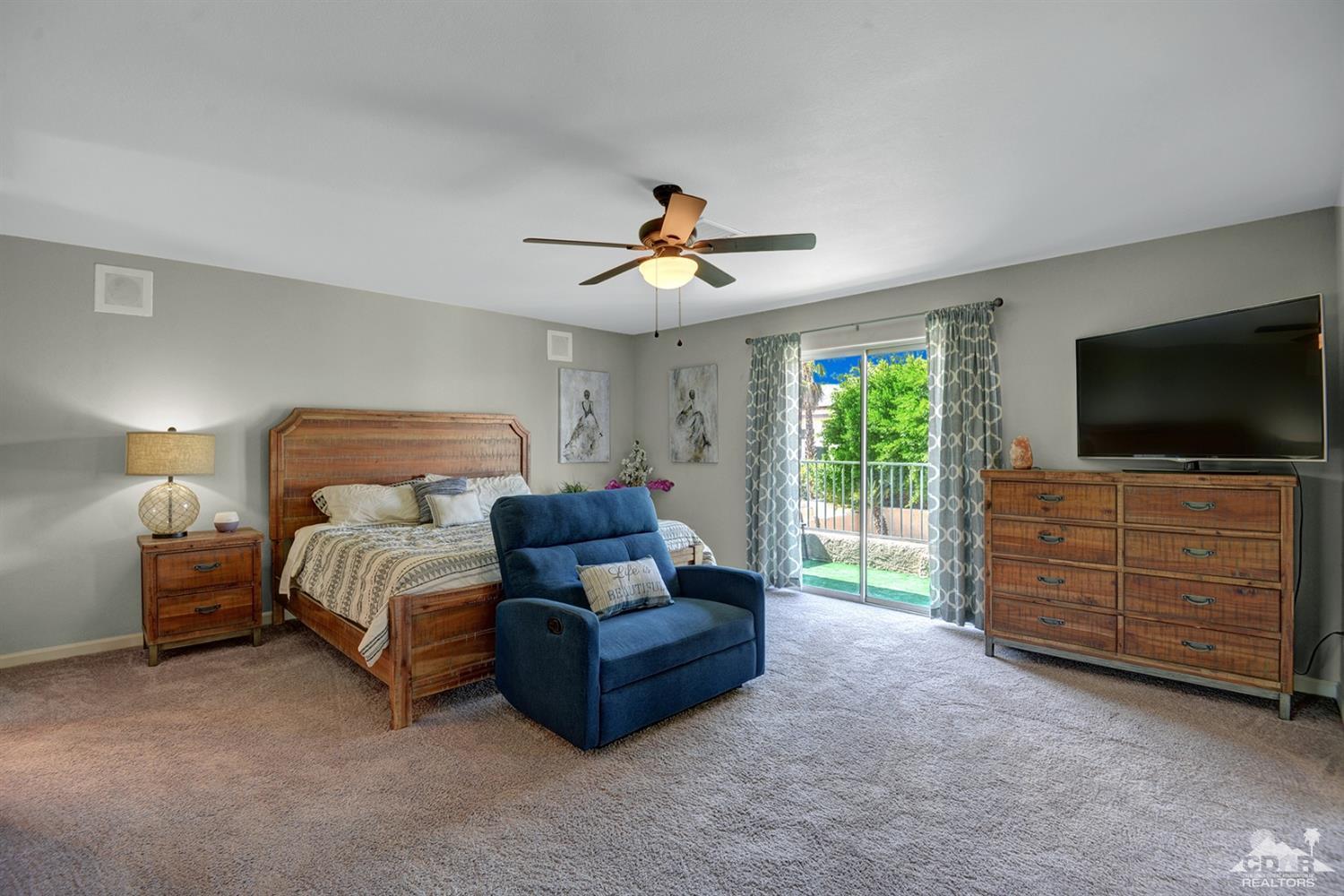 68710 Raposa Road Cathedral City, CA 92234 - Photo 14 of 29 a bedroom with furniture and a flat screen tv