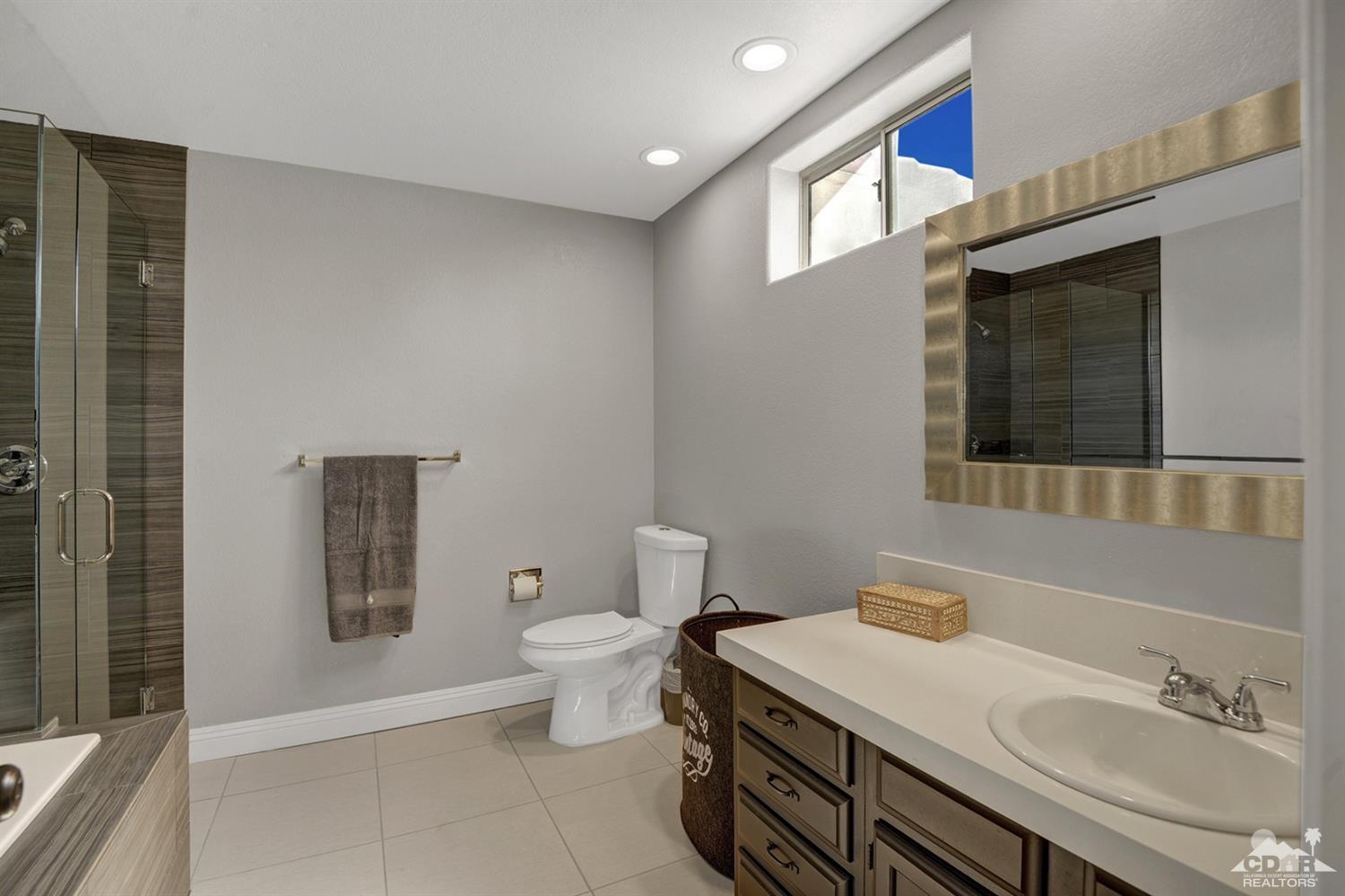 68710 Raposa Road Cathedral City, CA 92234 - Photo 17 of 29 a bathroom with a sink toilet and mirror