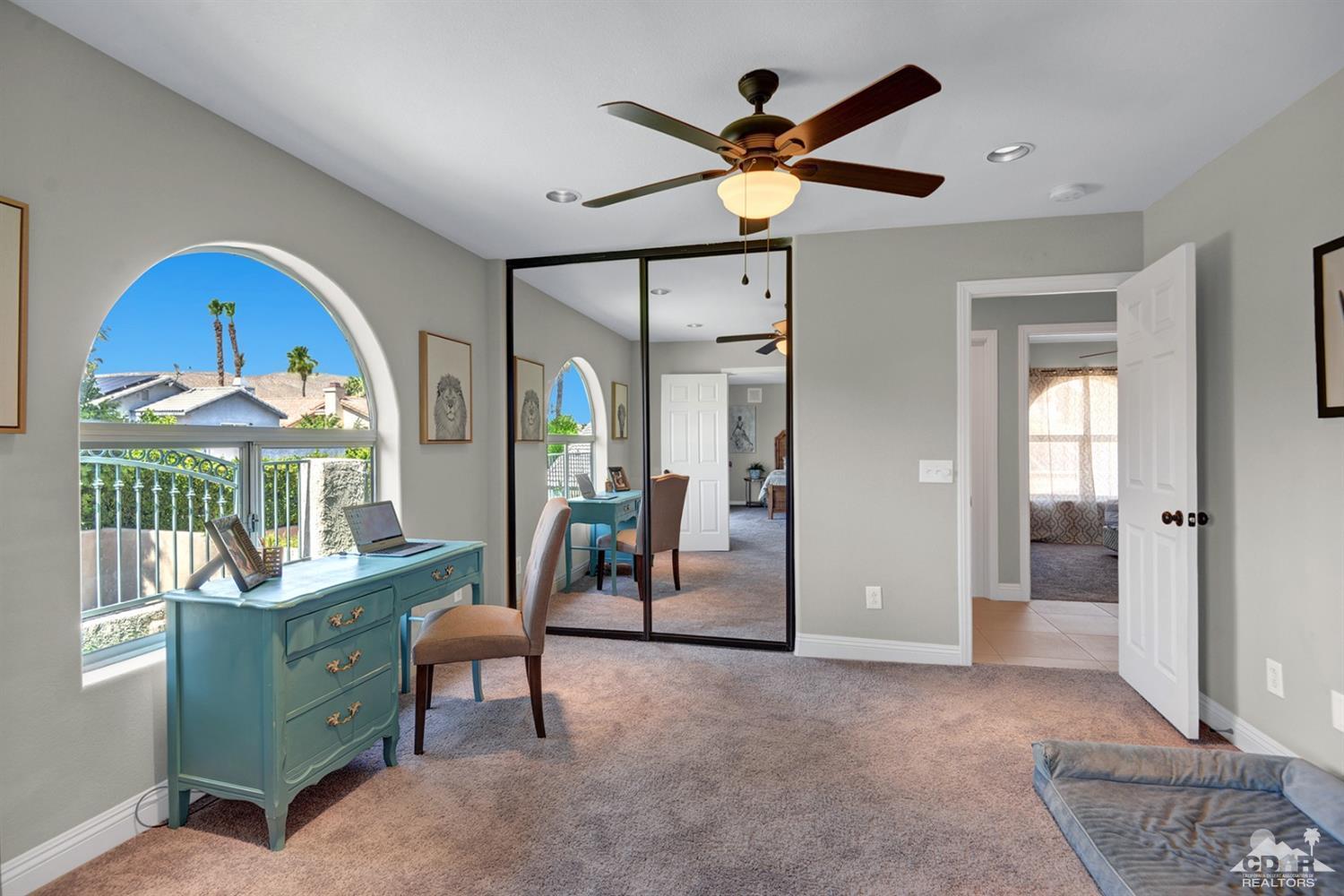 68710 Raposa Road Cathedral City, CA 92234 - Photo 20 of 29 a living room with furniture a window and a chandelier