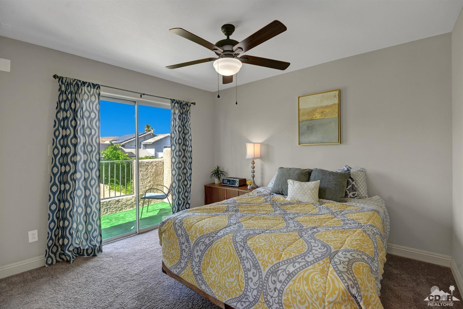 68710 Raposa Road Cathedral City, CA 92234 - Photo 21 of 29 a bedroom with a bed and a ceiling fan