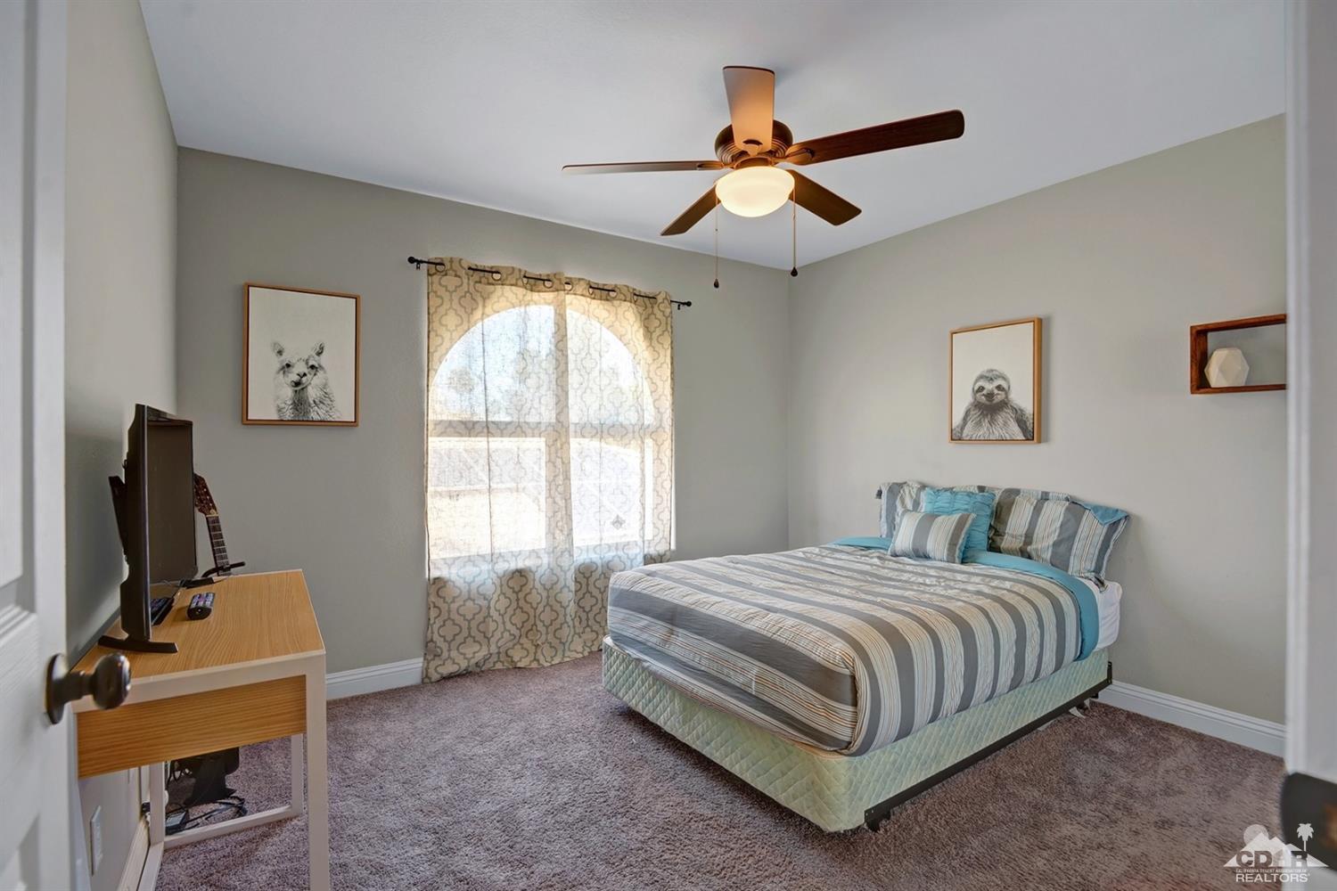 68710 Raposa Road Cathedral City, CA 92234 - Photo 23 of 29 a bedroom with a bed and a window