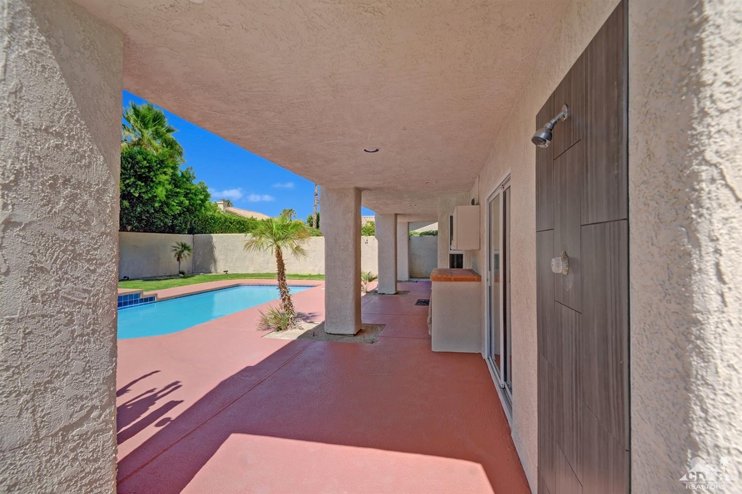 68710 Raposa Road Cathedral City, CA 92234 - Photo 26 of 29 a bedroom with a bed and a window