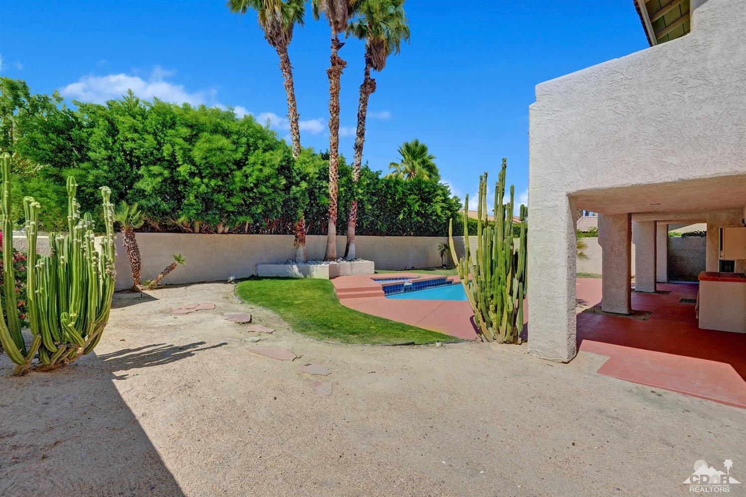 68710 Raposa Road Cathedral City, CA 92234 - Photo 27 of 29 a view of a patio with table and chairs potted plants and palm tree
