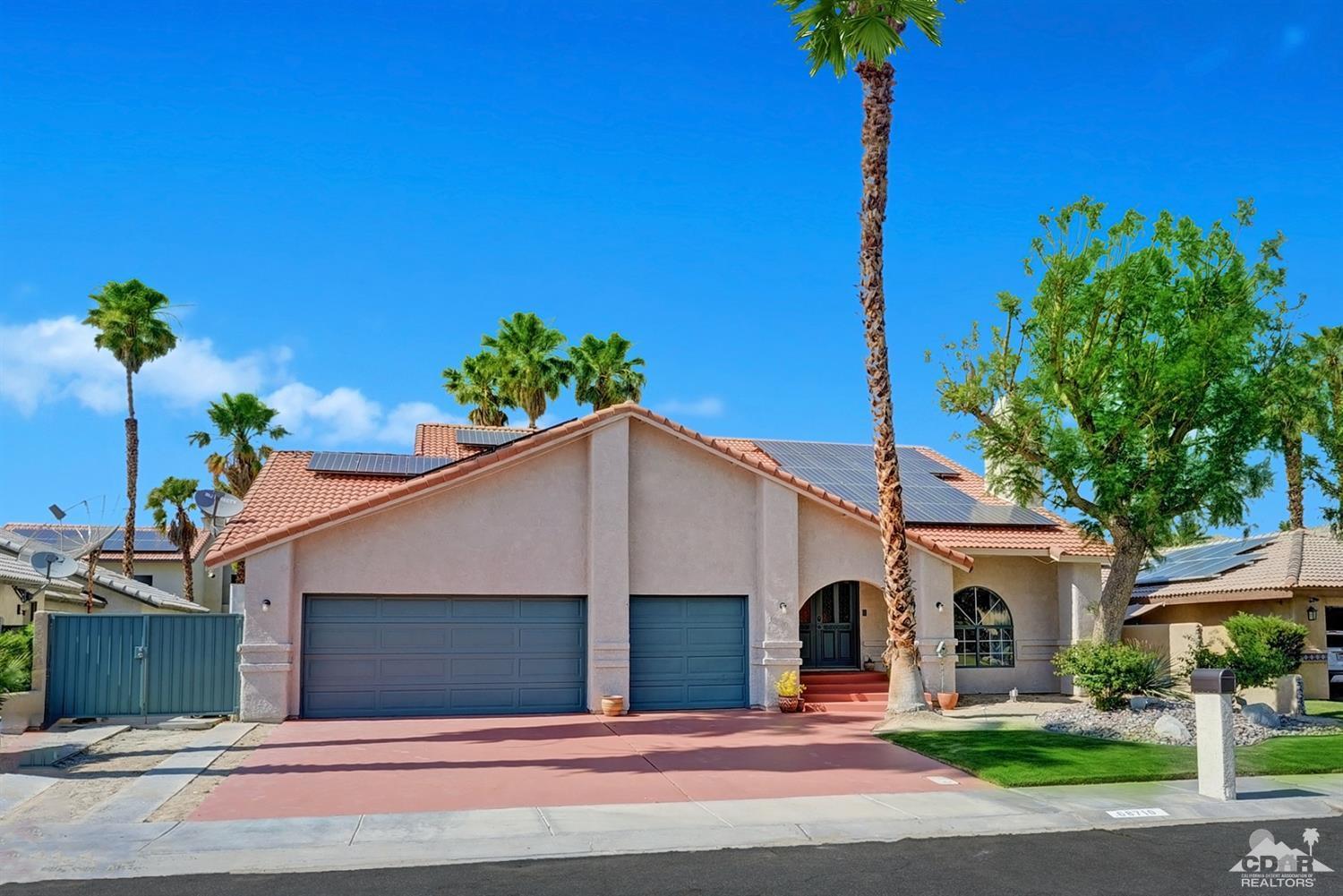 68710 Raposa Road Cathedral City, CA 92234 - Photo 28 of 29 a view of a house with a yard and garage