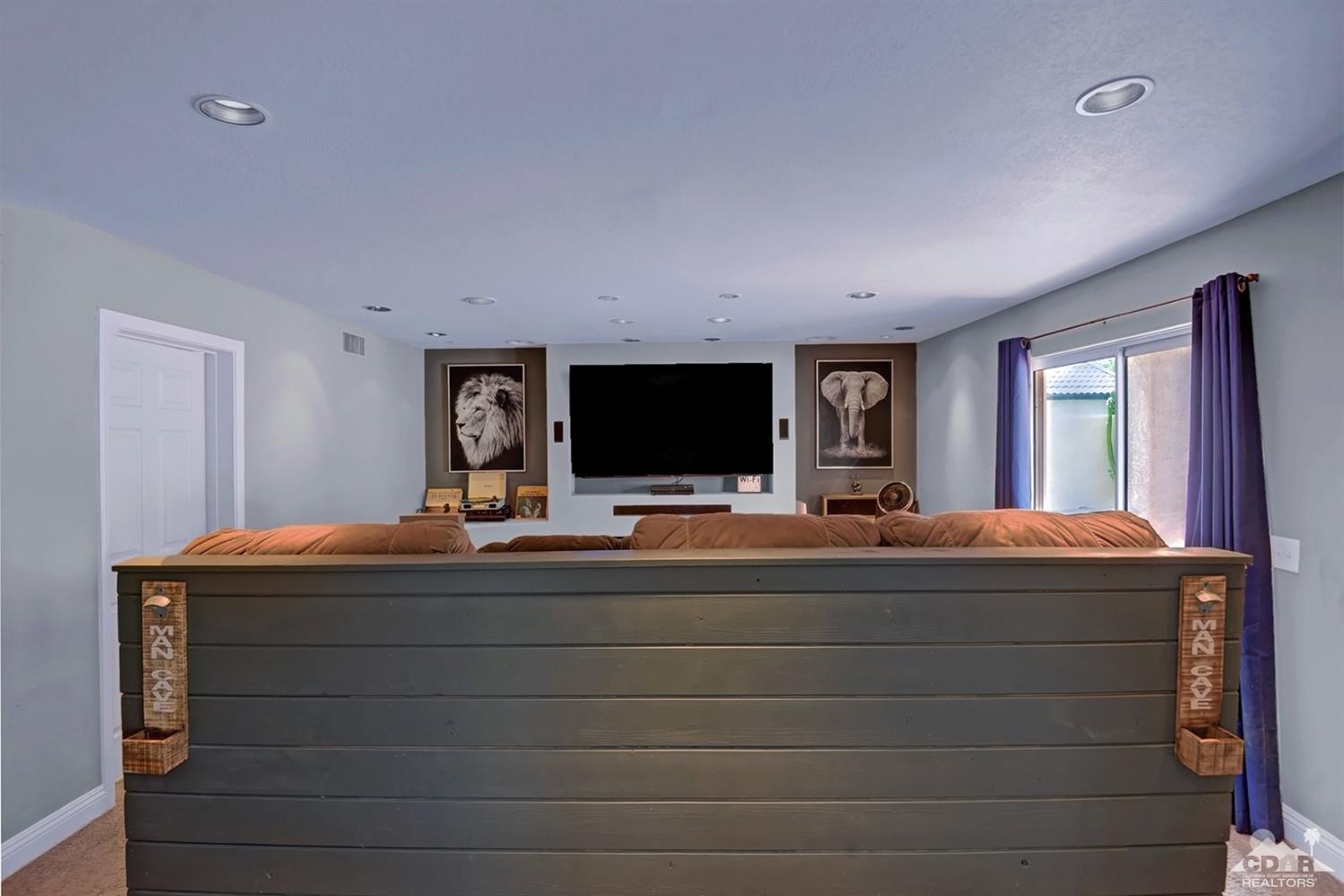 68710 Raposa Road Cathedral City, CA 92234 - Photo 8 of 29 a room with a bed and a flat tv screen