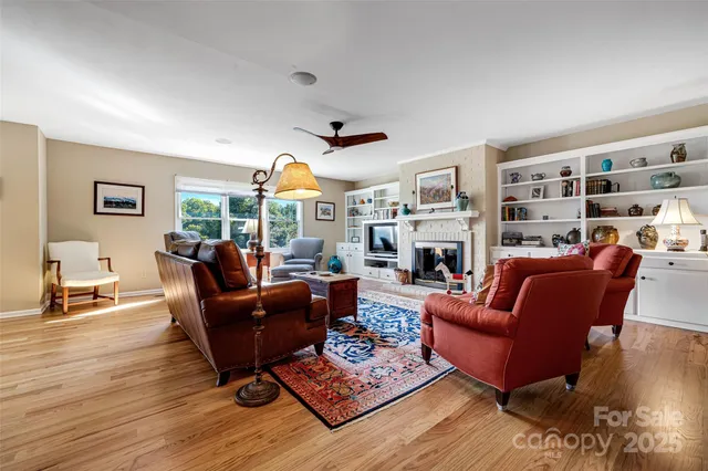 a living room with furniture fireplace and a table