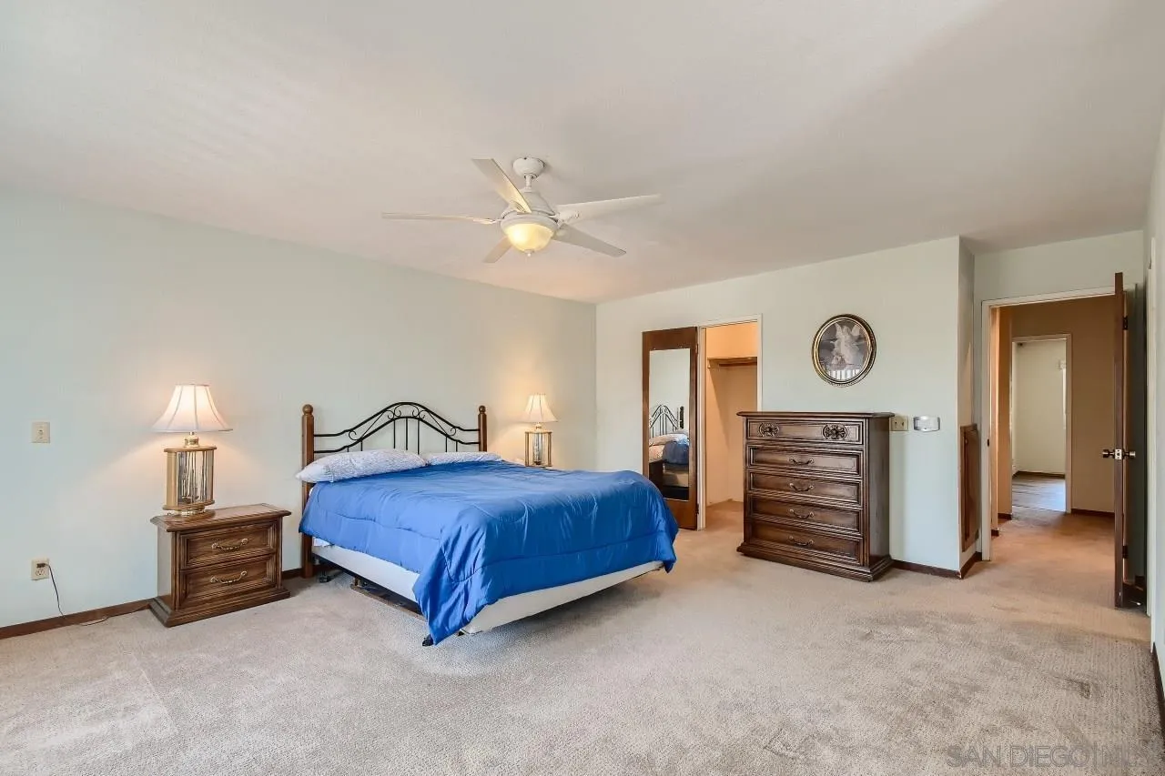396 El Monte Road El Cajon, CA 92020 - Photo 13 of 18 a bedroom with a bed and a ceiling fan